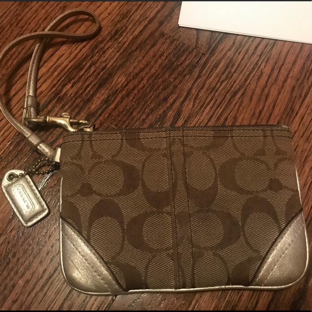 Traditional coach wristlet with gold detail